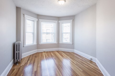 Living Room with Hardwood Floors and Three Windows